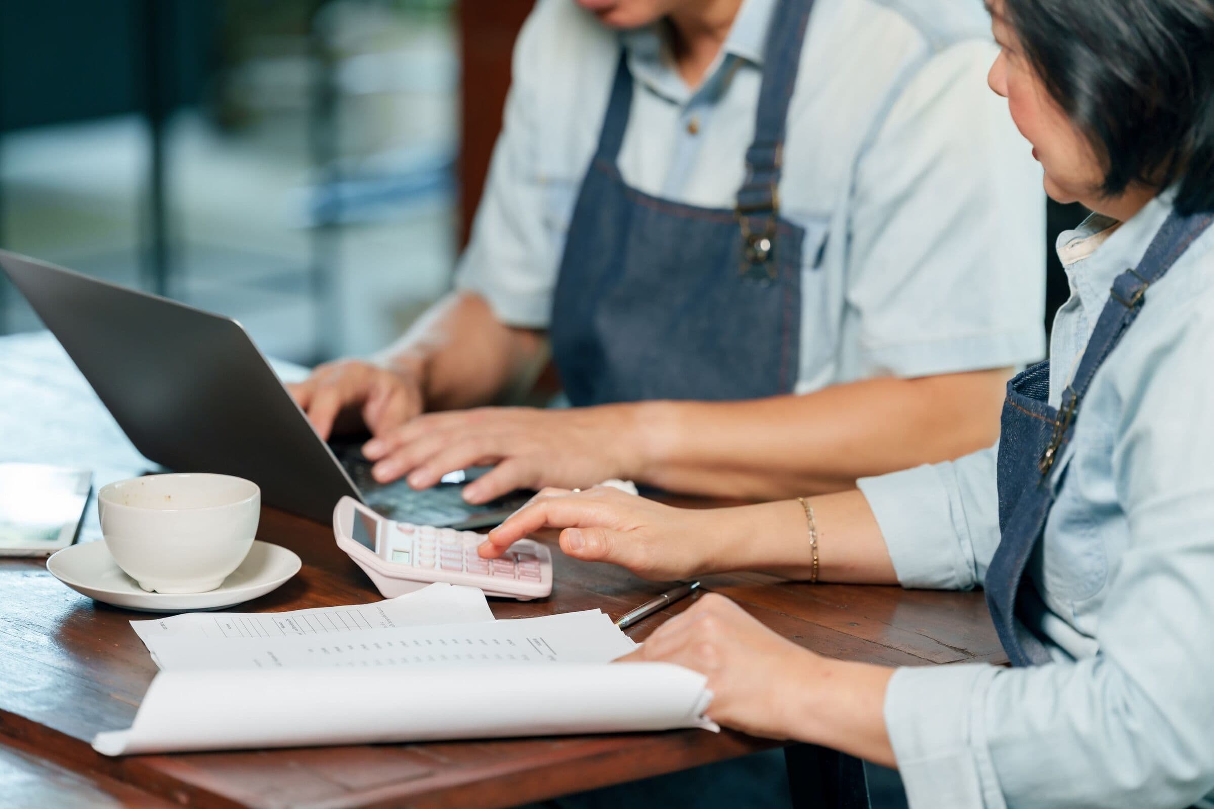 Small business owners reviewing finances together